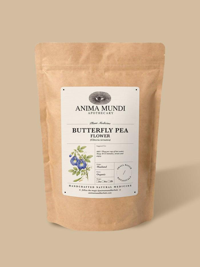 A kraft paper stand-up pouch of Anima Mundi Apothecary Butterfly Pea Flower herbal tea, set against a solid beige background.