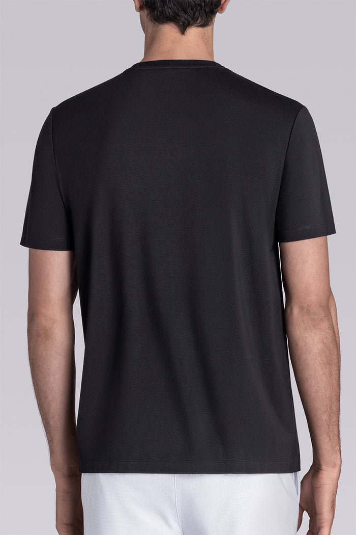 Model wearing Fundamental Black Icy Bamboo® short sleeve crewneck, styled with white shorts.