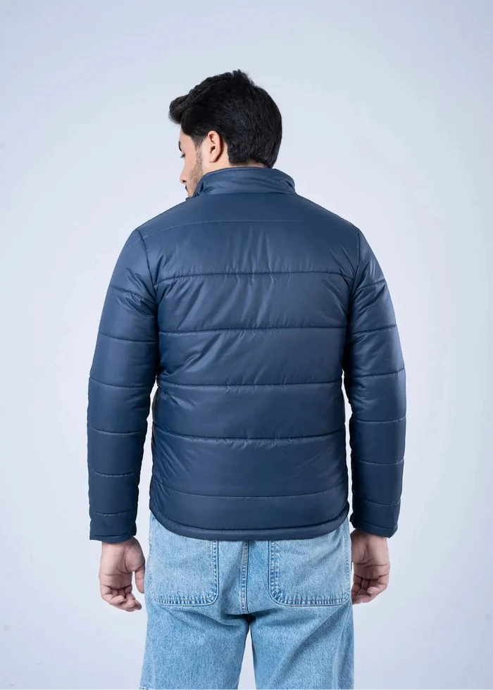 Men's navy quilted bubble jacket, back view with banded hem