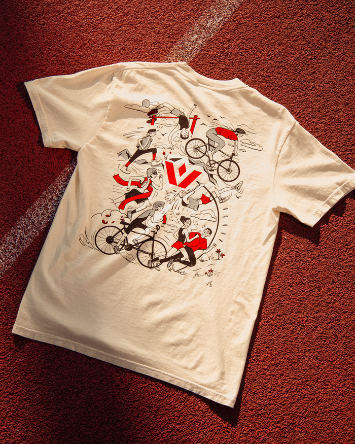 White Swiftwick tshirt with black and red cartoon characters that is laying on the ground
