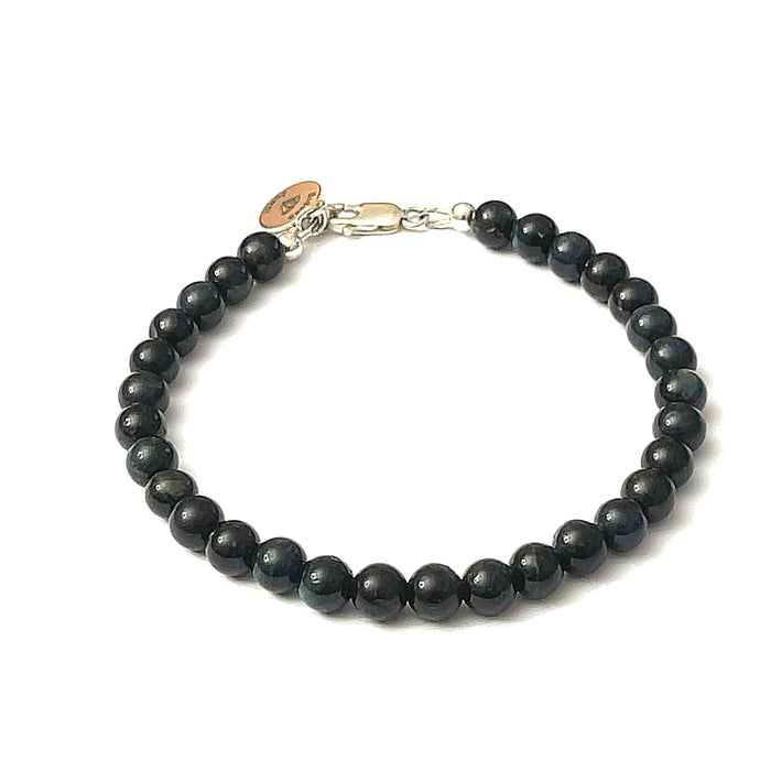6mm Blue Tiger Eye gemstone beaded bracelet with sterling silver lobster claw clasp showing deep midnight blue chatoyant bands on a white background, front view.