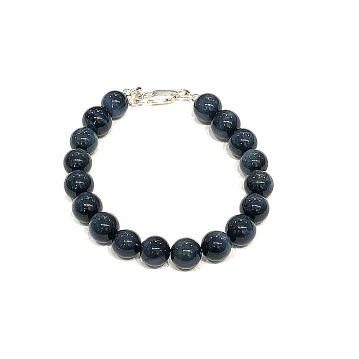 8.5mm Blue Tiger Eye gemstone beaded bracelet with sterling silver lobster claw clasp showing deep midnight blue chatoyant bands on a white background, front view.