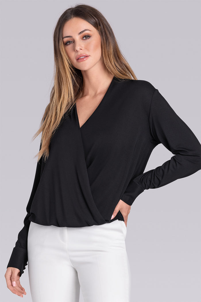 Female Model wearing Blush Black Icy Bamboo® womens long sleeve wrap top, styled with white pants.
