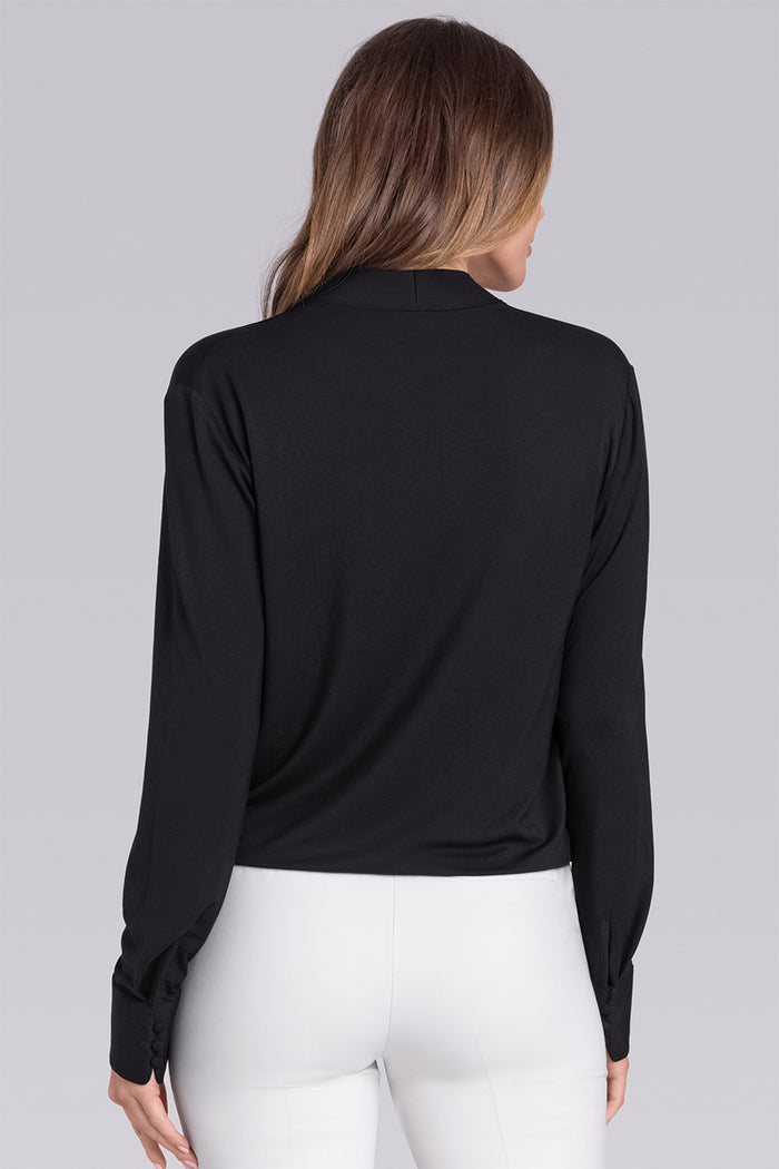 Female Model wearing Blush Black Icy Bamboo® womens long sleeve wrap top, styled with white pants.