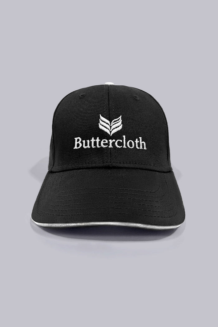Model wearing the sleek Black Buttercloth Hat cap comfortable headwear.