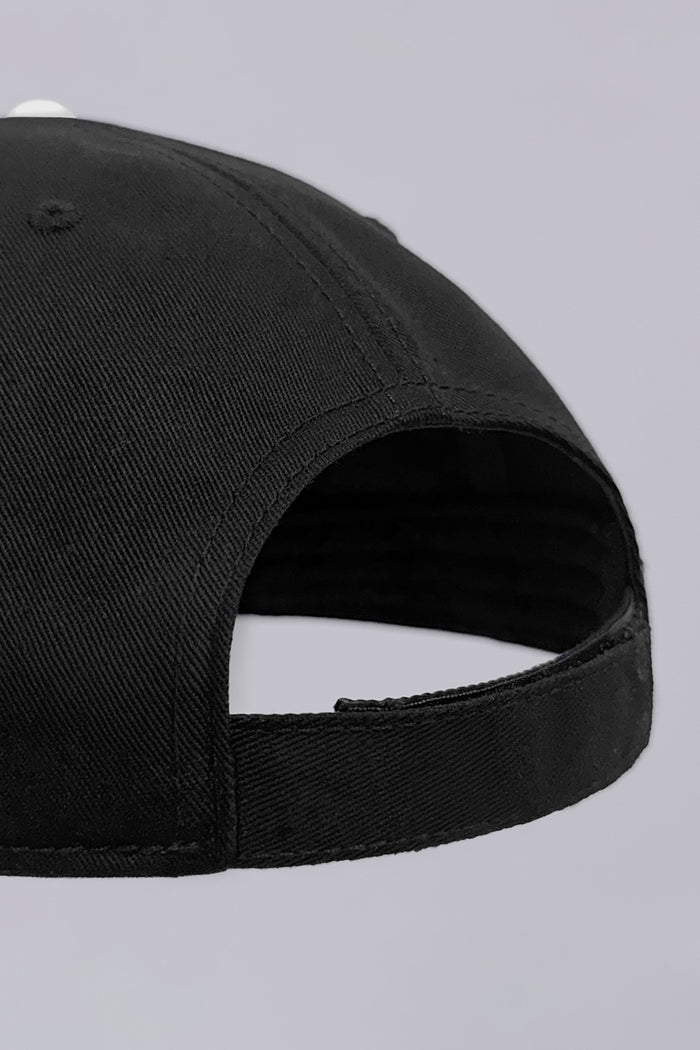 Model wearing the sleek Black Buttercloth Hat cap comfortable headwear.