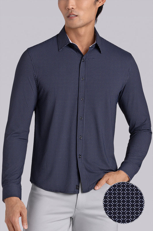 Model wearing the Captivate Dark Navy long sleeve dress shirt, styled with fitted light grey dress slacks.