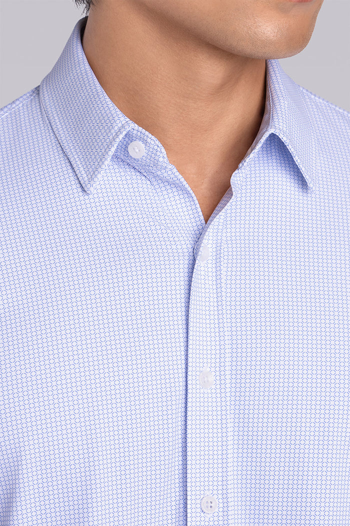 Model wearing the Captivate White Blue long sleeve dress shirt, styled with fitted black dress slacks.
