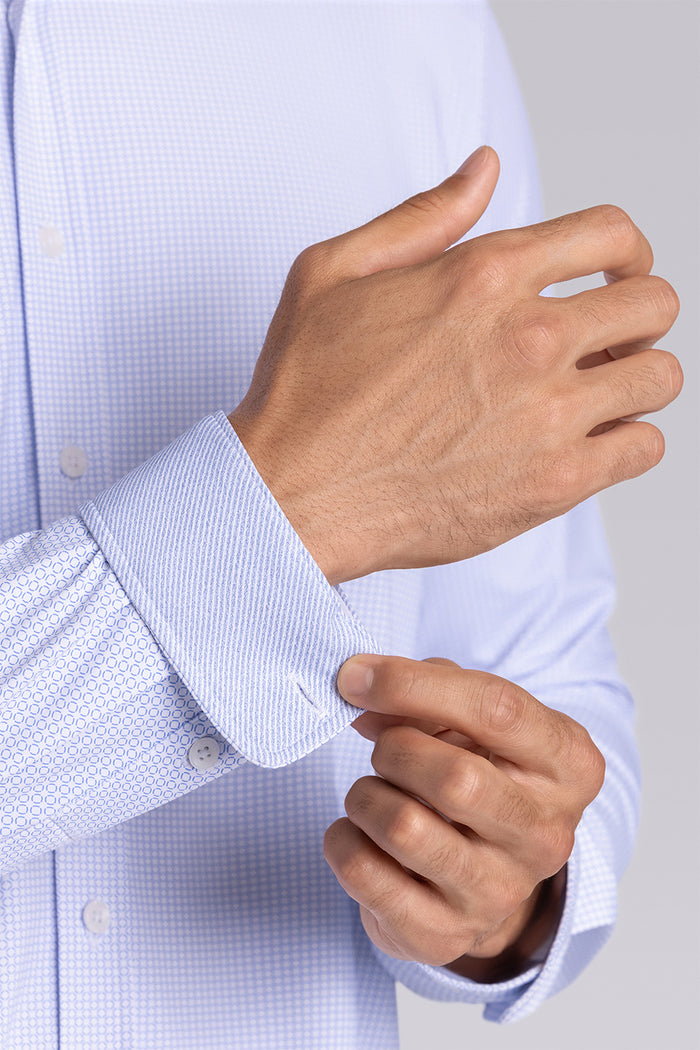 Model wearing the Captivate White Blue long sleeve dress shirt, styled with fitted black dress slacks.