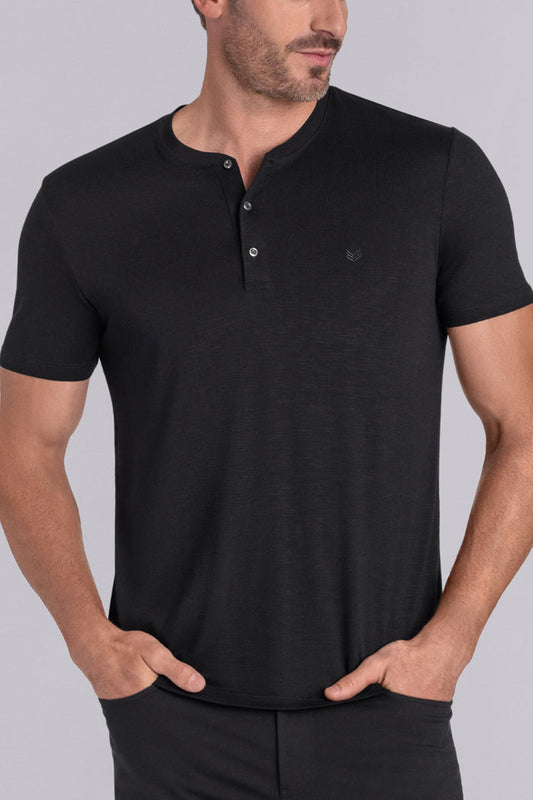 Model wearing Cardinal Black soft short sleeve shirt, styled with fitted black pants