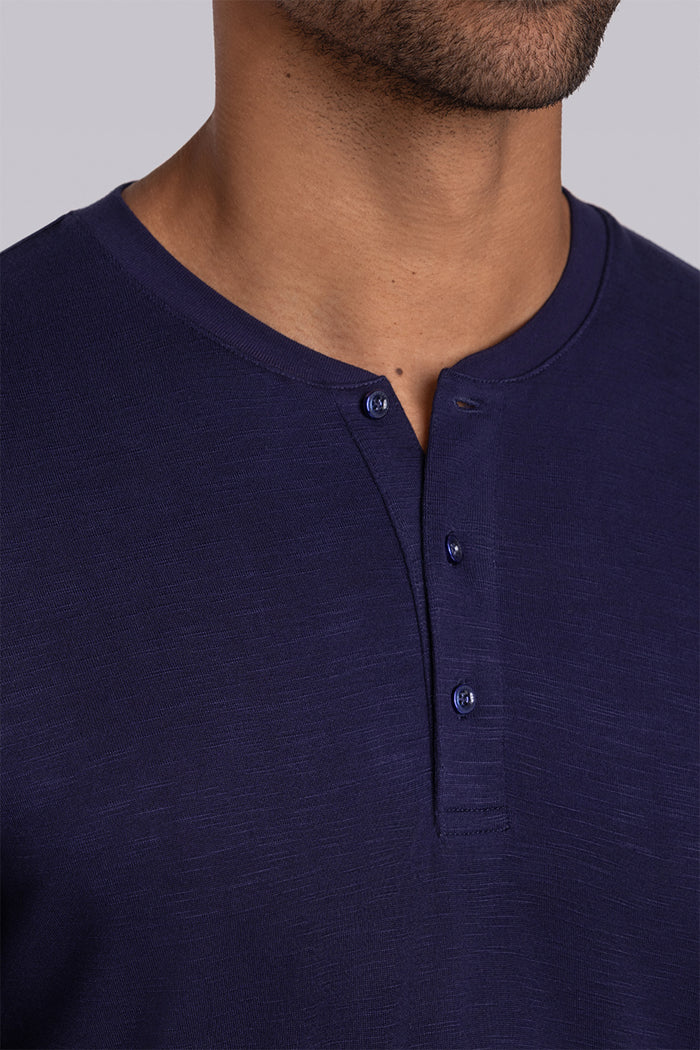 Model wearing Cardinal Navy soft short sleeve shirt, styled with fitted light grey pants
