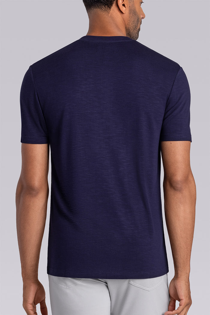 Model wearing Cardinal Navy soft short sleeve shirt, styled with fitted light grey pants