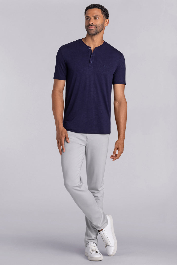 Model wearing Cardinal Navy soft short sleeve shirt, styled with fitted light grey pants