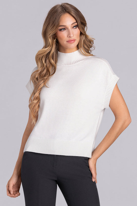 Model wearing the Charisma Off White short sleeve knit shirt, styled with black pants.