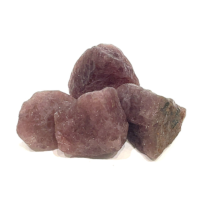 A collection of raw cherry  tanzurine gemstones against a white background, front overview.