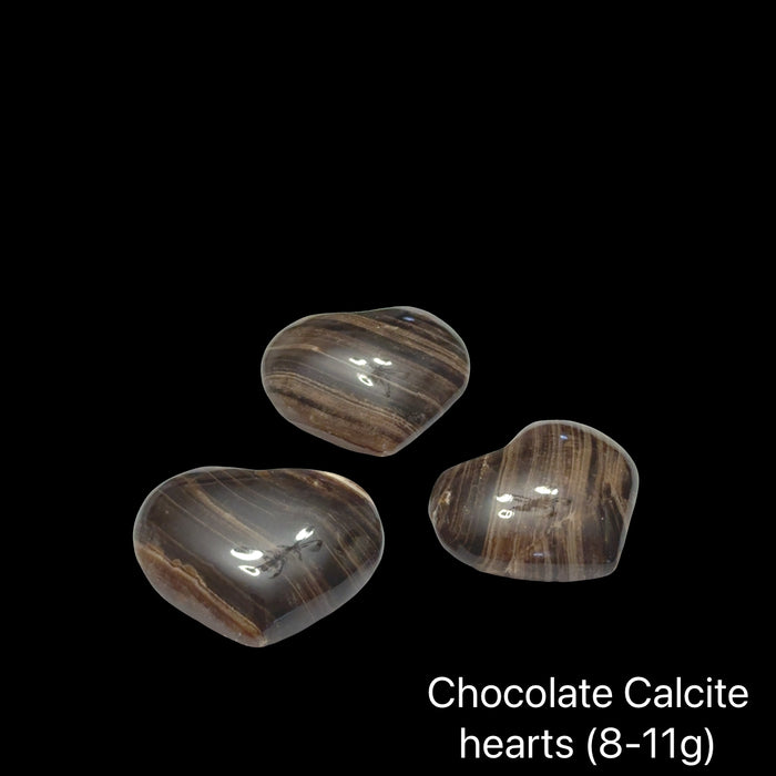 Three chocolate calcite hearts (8-11g) on a black background, front view.