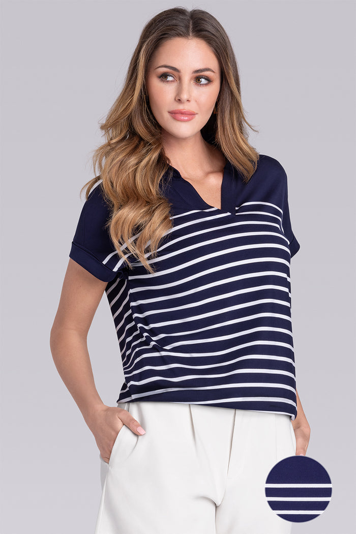 Model wearing the Conquest Deep Sea Blue White Icy Bamboo® cap sleeve tee, styled with white shorts.