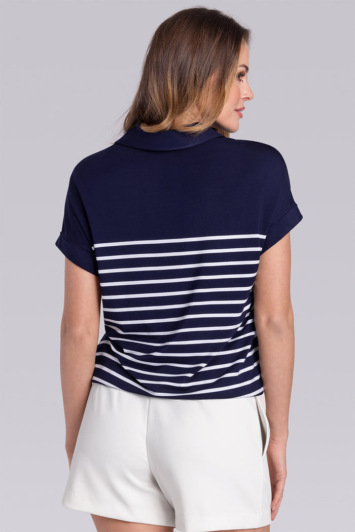 Model wearing the Conquest Deep Sea Blue White Icy Bamboo® cap sleeve tee, styled with white shorts.