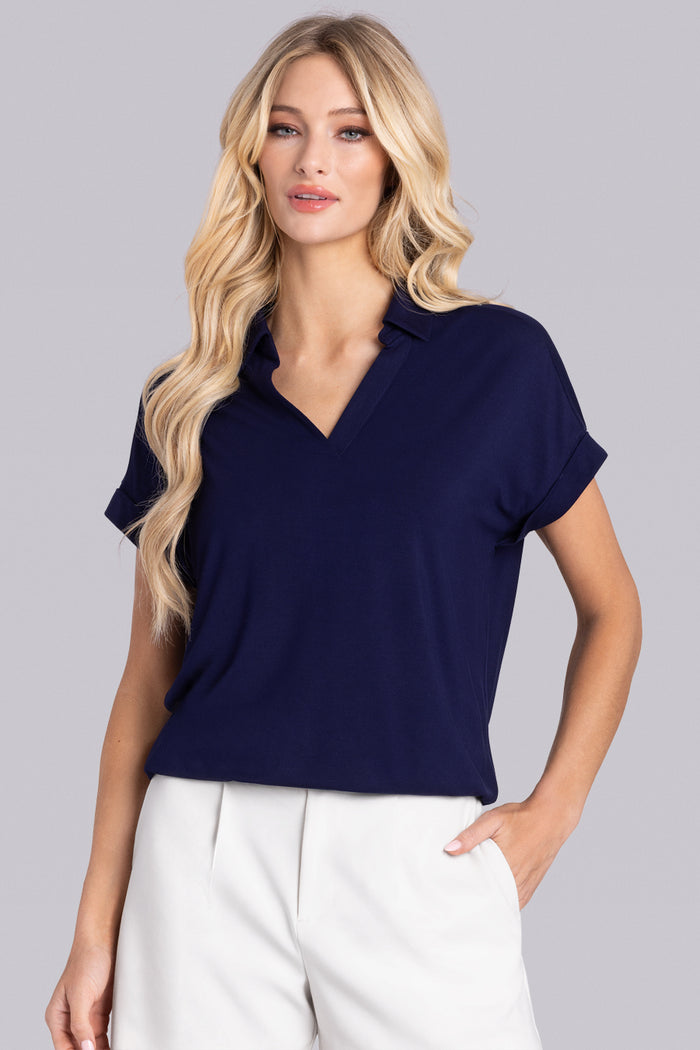 Model wearing the Conquest Deep Sea Blue Icy Bamboo® cap sleeve tee, styled with white shorts.