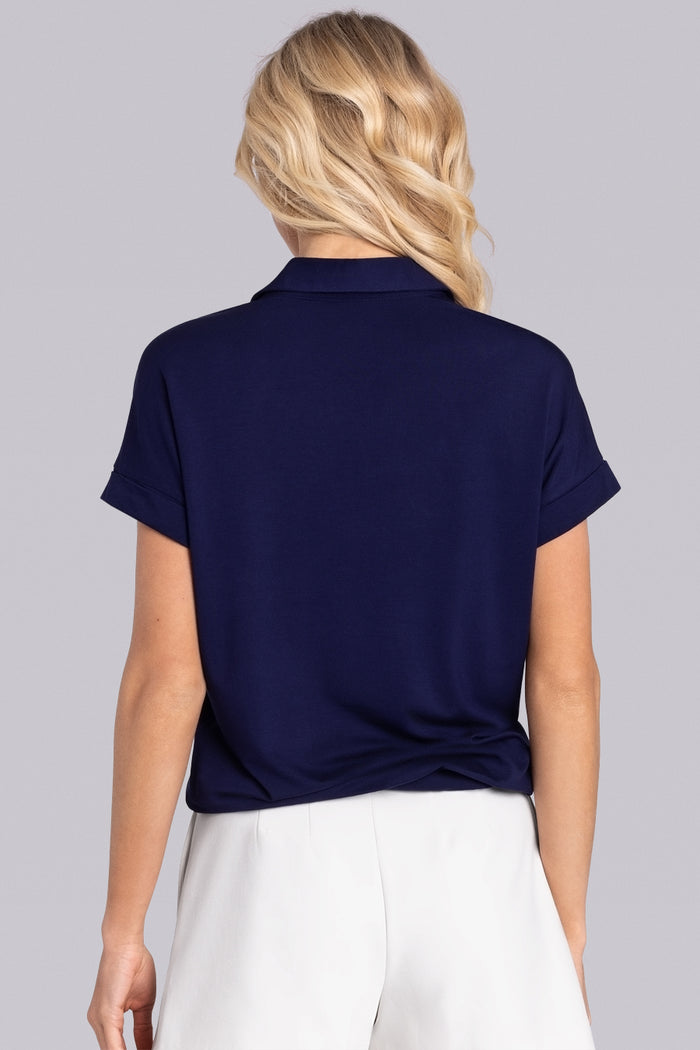 Model wearing the Conquest Deep Sea Blue Icy Bamboo® cap sleeve tee, styled with white shorts.