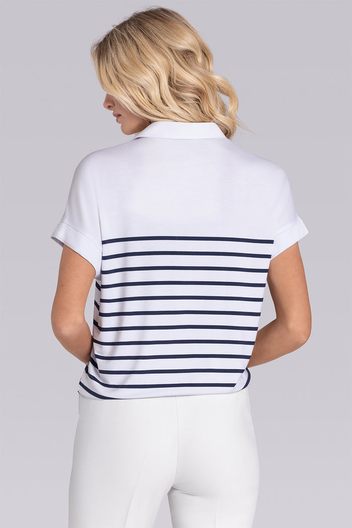 Model wearing the Conquest White Navy Icy Bamboo® short sleeve notched neck shirt, styled with white pants.