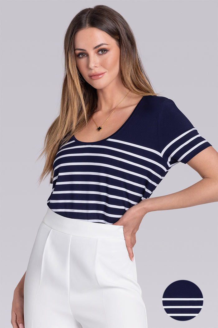 Model wearing the Daydream Deep Sea Blue White scoop neck stripped short sleeve tee, styled with white pants
