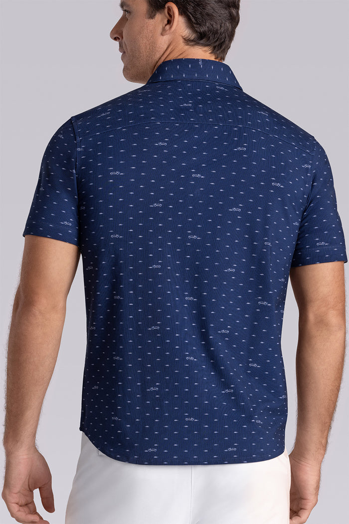 Model wearing Drift Dark Navy short sleeve car print shirt, styled with white shorts