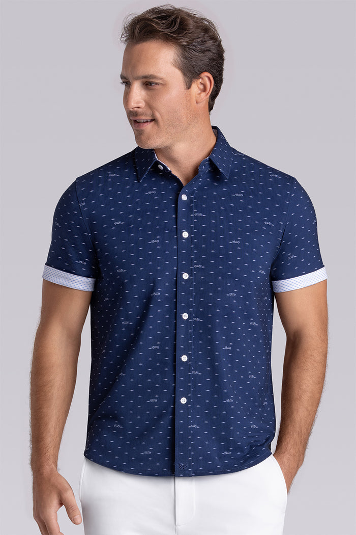 Model wearing Drift Dark Navy short sleeve car print shirt, styled with white shorts