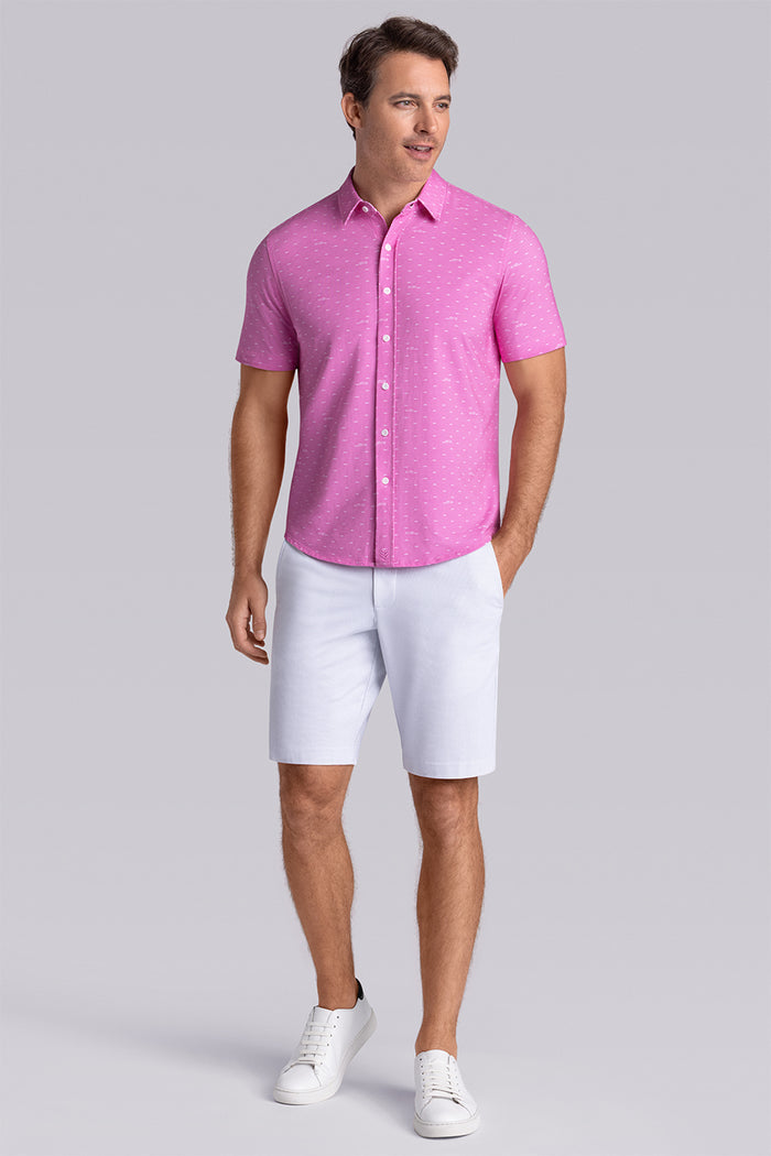 Model wearing Drift Fuchsia Red short sleeve car print shirt, styled with white shorts