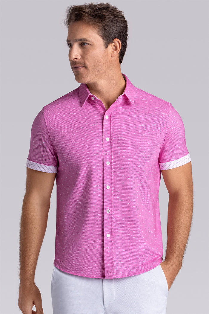 Model wearing Drift Fuchsia Red short sleeve car print shirt, styled with white shorts