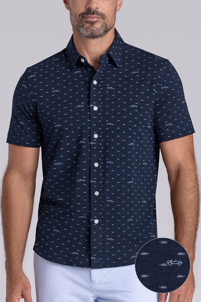 Model wearing Drift Legion Blue Heather short sleeve car print shirt, styled with white shorts
