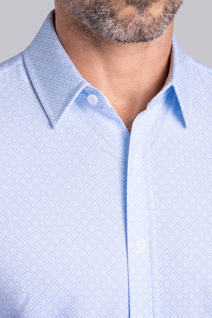 Model wearing Echo Haze Blue long sleeve tonal geometric print shirt, styled with black pants.