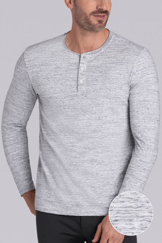 Model wearing Elemental Bone White Heather long sleeve henley shirt, styled with black pants.