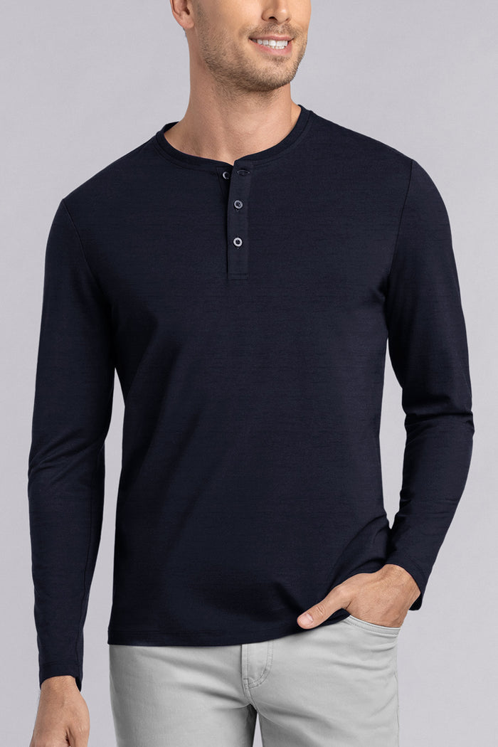 Model wearing Elemental Navy long sleeve henley shirt, styled with black pants.