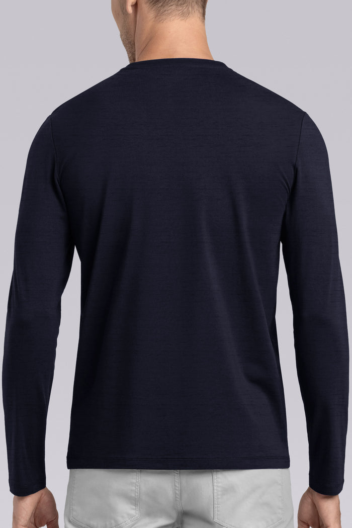 Model wearing Elemental Navy long sleeve henley shirt, styled with black pants.
