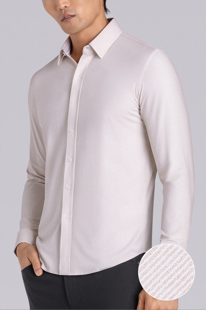 Model wearing the Elusive Champagne long sleeve dress shirt, styled with fitted black dress slacks.