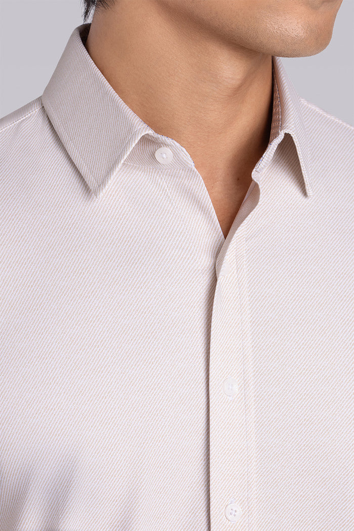 Model wearing the Elusive Champagne long sleeve dress shirt, styled with fitted black dress slacks.