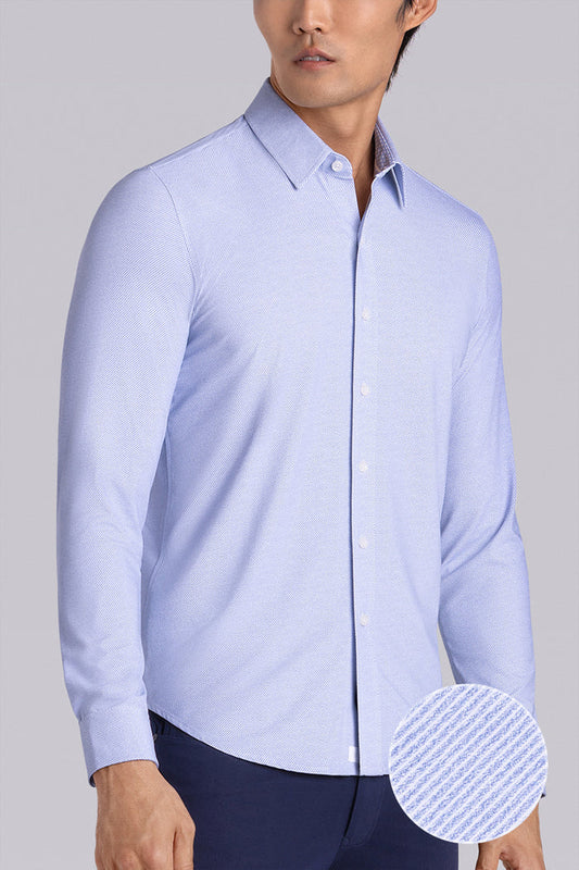 Model wearing the Elusive Light Blue long sleeve dress shirt, styled with fitted black dress slacks.