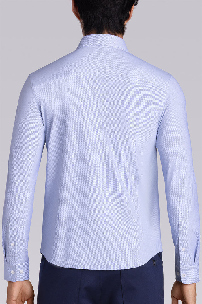 Model wearing the Elusive Light Blue long sleeve dress shirt, styled with fitted black dress slacks.