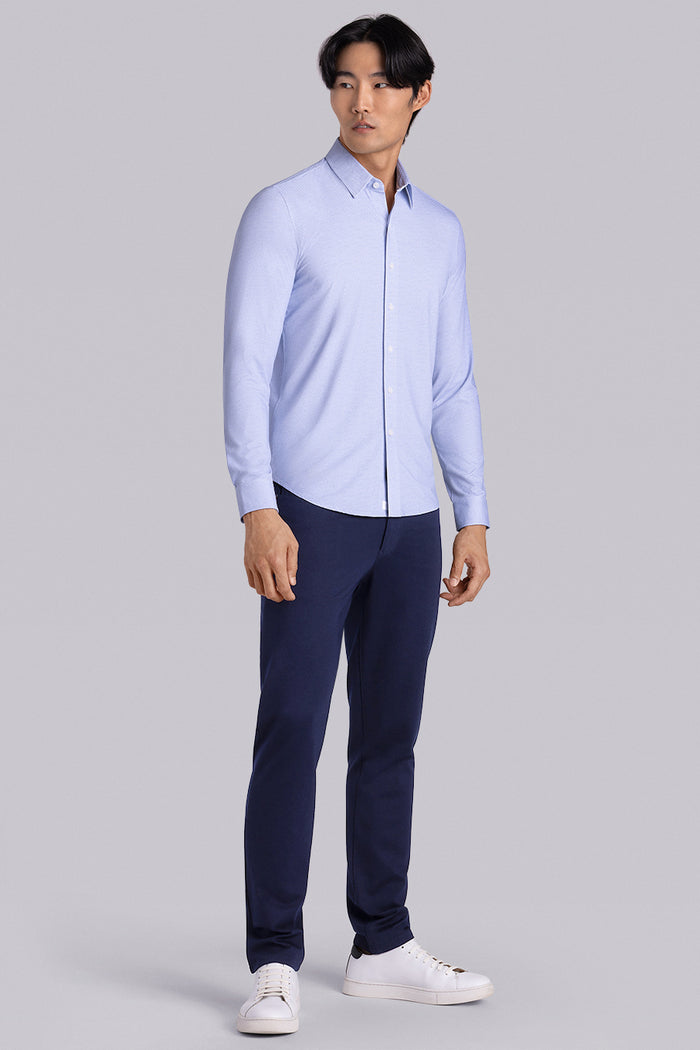 Model wearing the Elusive Light Blue long sleeve dress shirt, styled with fitted black dress slacks.