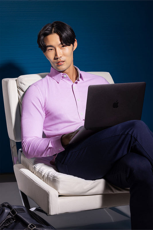 Model wearing the Elusive Pink long sleeve dress shirt, styled with fitted black dress slacks.