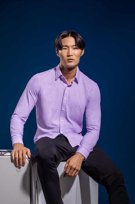 Model wearing the Elusive Purple long sleeve dress shirt, styled with fitted black dress slacks.