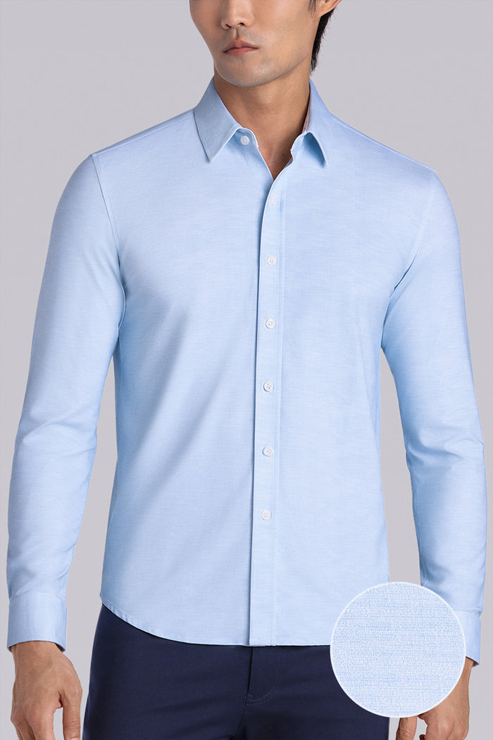 Model wearing the Elusive Seafoam long sleeve dress shirt, styled with fitted black dress slacks.