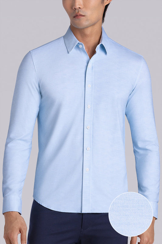 Model wearing the Elusive Seafoam long sleeve dress shirt, styled with fitted black dress slacks.