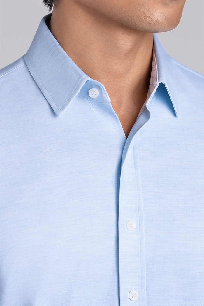 Model wearing the Elusive Seafoam long sleeve dress shirt, styled with fitted black dress slacks.
