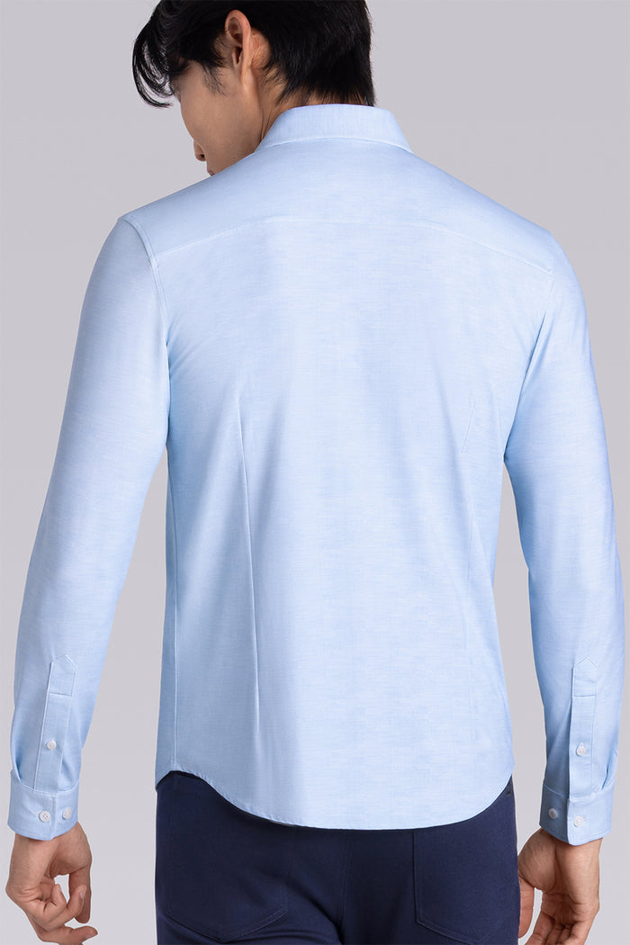 Model wearing the Elusive Seafoam long sleeve dress shirt, styled with fitted black dress slacks.