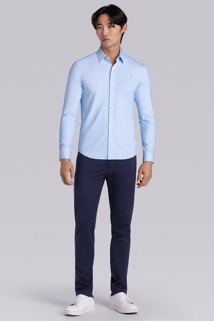 Model wearing the Elusive Seafoam long sleeve dress shirt, styled with fitted black dress slacks.