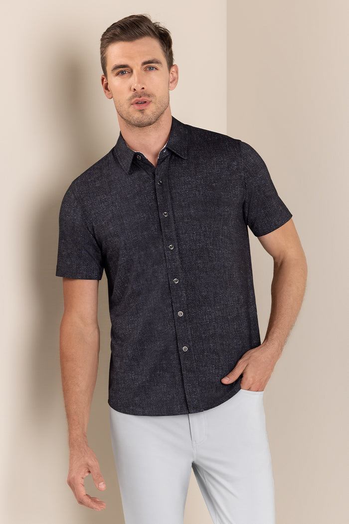 Model wearing Eminent Black short sleeve print shirt, styled with white pants.