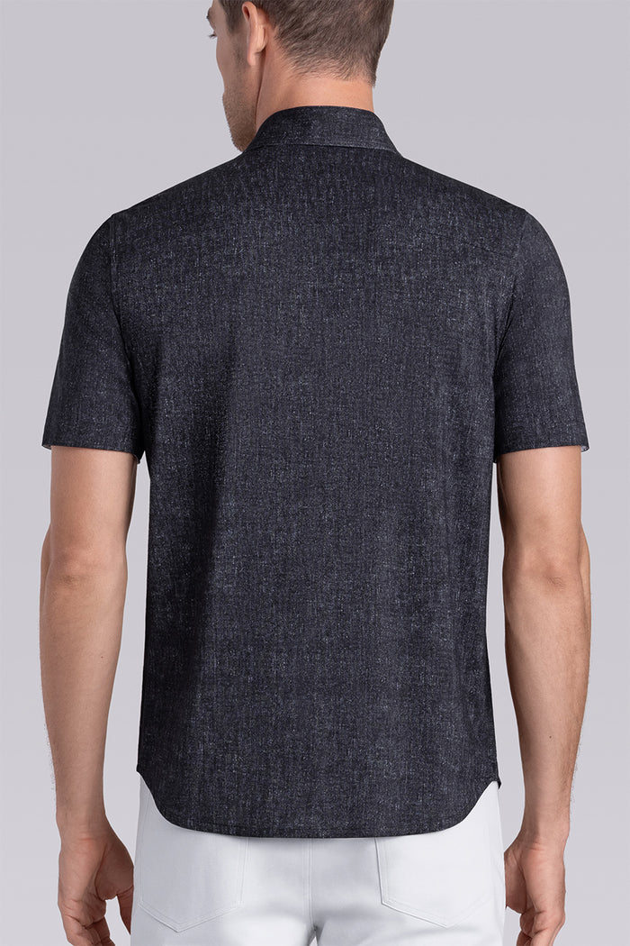 Model wearing Eminent Black short sleeve print shirt, styled with white pants.