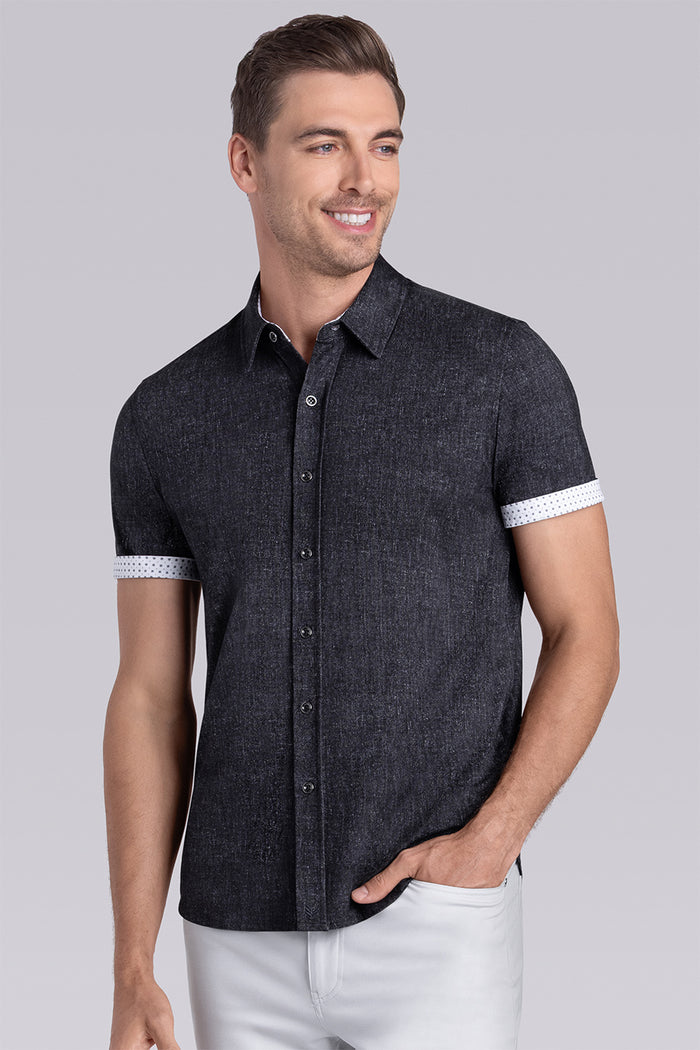 Model wearing Eminent Black short sleeve print shirt, styled with white pants.